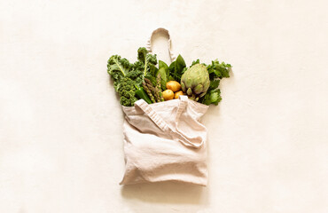 Fresh green produce in reusable shopping bag, top down view