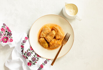 National Ukrainian cuisine dish Golubtsy served with sour cream, top-down view