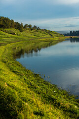 Naklejka premium Beautiful Landscape with lake and trees. Amazing Nature in Europe. Lovely place to visit this summer.