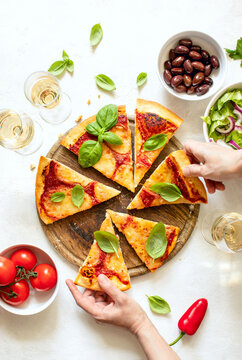 Italian pizza Margherita served with white wine, top-down view