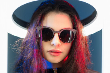 Tech fashion. Cyberpunk eyewear. Futuristic style. Art portrait of red pink neon light fantastic...