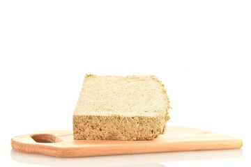 One slice of vanilla halva on a wooden board, close-up, isolated on white.