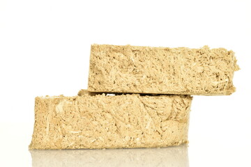 Two slices of vanilla halva, close-up, isolated on white.