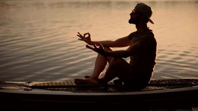 Tourist Meditation Pose Sup Board On Vacation.Standup Paddle Board.Cross-Legged No Stress Leisure Surfing Boat Fitness Workout.Travel Water Tourism Holiday Vacation Meditation.Sport Recreation Sup Fun