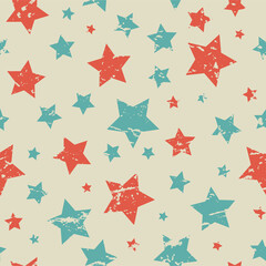 Seamless pattern with blue and red stars of different rotation and size on beige background.