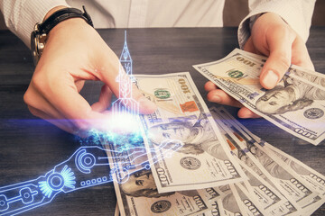Multi exposure of creative drawing hologram and USA dollars bills and man hands. Start up concept