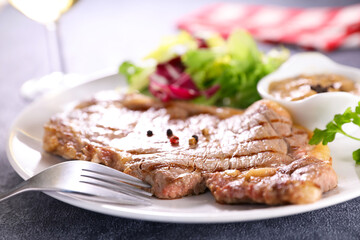 grilled beef steak with sauce and lettuce