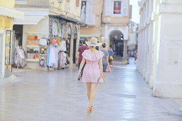 Fototapeta premium tourism summer old town female, europe mediterranean, young woman traveler, back straw hat view