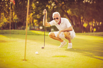 Senior man playing golf. Caucasian golfer man.