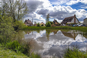 Reflections in the duck pond in the village of Bacton in Suffolk, UK