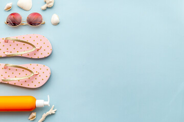 Tropical summer vacation background. Flip flops with towel and sunglasses