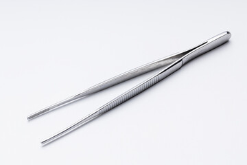 medical tweezers isolated on white background. surgery pincers cut out - obrazy, fototapety, plakaty
