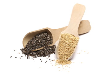 Chia and amaranth seeds in wooden spoons isolated on white background