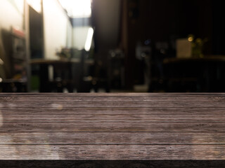 Empty wooden table top with lights bokeh on blur restaurant background.