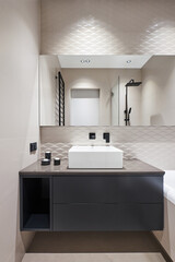 White square ceramic sink in a monochrome minimalist bathroom
