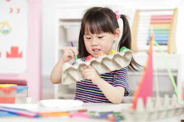 young girl hand making boat craft using egg cartons  for homeschooling