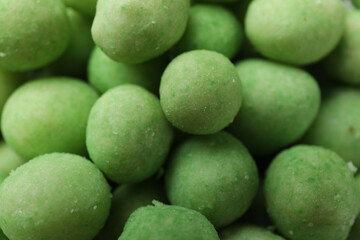 Tasty wasabi nuts on whole background, close up