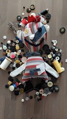 Rag doll, handicrafts, buttons instead of eyes. Stuffed, soft, light. Emotional doll. White with buttons. little boy. Cheerful, smiling, joyful, happy, striped. Blue, red, beige, toy. 