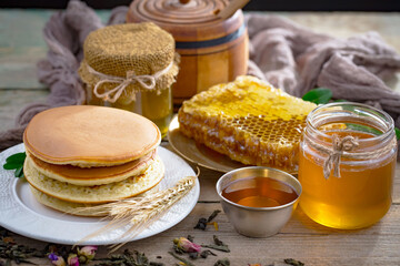 Sweet honey, with kitchen accessories in the composition on the table.
