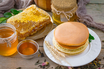 Sweet honey with flowers on an old background.