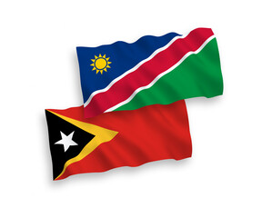 National vector fabric wave flags of Republic of Namibia and East Timor isolated on white background. 1 to 2 proportion.