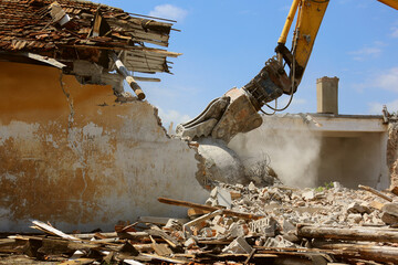 Tracked excavator demolishing old buildings