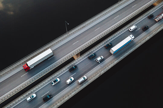 Aerial View Of Traffic Vehicles Driving On The Highway Bridge Over The Neman River In Kaunas, Lithuania.