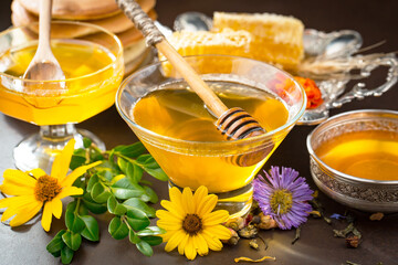 Sweet honey with flowers on an old background.
