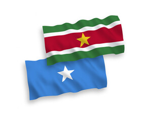 National vector fabric wave flags of Republic of Suriname and Somalia isolated on white background. 1 to 2 proportion.