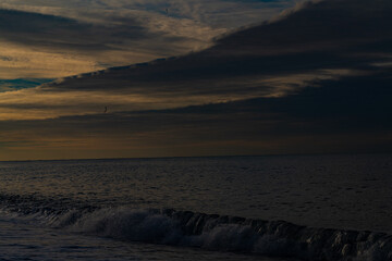 Yellow sunset on the background of clouds