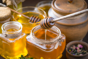 Sweet honey with flowers on an old background.