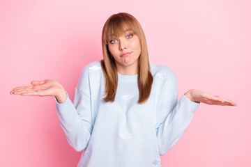 Portrait of attractive unsure girl shrugging shoulders dont know isolated over pink pastel color background