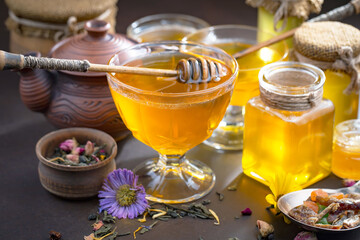 Sweet honey with flowers on an old background.