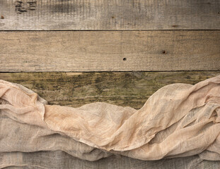 folded gauze towel on a table made of old gray wooden boards