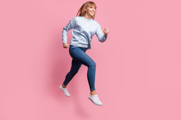 Fototapeta na wymiar Full length body size view of pretty motivated cheerful girl jumping running healthy life isolated over pink pastel color background