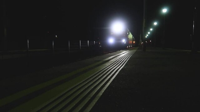 VINTU DE JOS, ROMANIA - Aug 18, 2020: Train passing in the train station at night