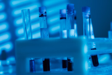 Detail of test tubes on laboratory table, with blue light environment