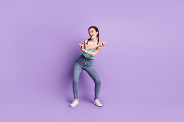 Full length body size view of pretty cheerful carefree girl dancing moving having fun isolated over violet purple color background