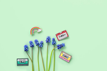 rainbow, mini audio cassettes and blue flowers on green background. Minimal style. Retro technology, aesthetic Nostalgia Creative concept. Retro wave. flat lay. copy space
