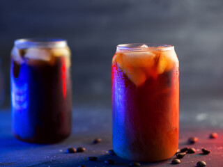 Two glasses of cold brew coffee . Colored neon backlight. Stylish summer menu in the cafe.