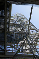 Outside geometrical construction with metal staircase on industrial complex 