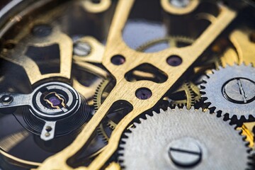 Gears and cogs inside clock. Close-up view on retro watches.