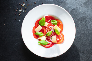 summer tomato salad veggie vegetable, cheese, onion diet vitamin on the table healthy food meal snack copy space food background rustic. top view vegan or vegetarian food