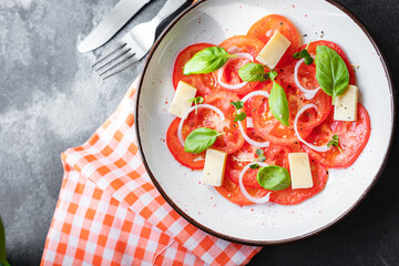 summer tomato salad veggie vegetable, cheese, onion diet vitamin on the table healthy food meal snack copy space food background rustic. top view vegan or vegetarian food