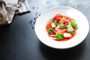 summer tomato salad veggie vegetable, cheese, onion diet vitamin on the table healthy food meal snack copy space food background rustic. top view vegan or vegetarian food