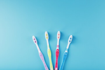 Colorful toothbrushes for the family on a blue background.
