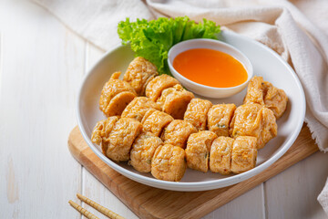 Deep fried fhicken roll on the white wooden background.