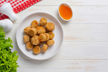 Deep fried fhicken roll on the white wooden background.