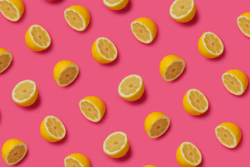 Summer food pattern made with fresh lemons on vibrant pink background. Creative fruit and vegetable texture concept. Healthy vegetarian diet composition.