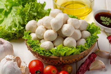 Pork meatballs on the white wooden background.